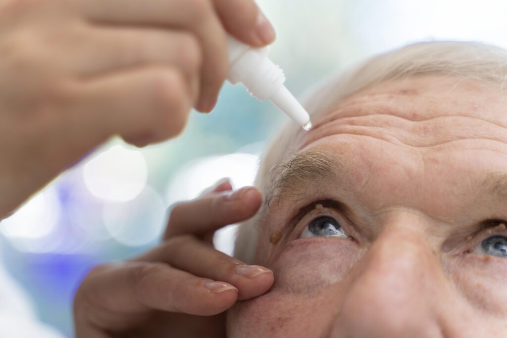 doctor pouring some eye drops patient
